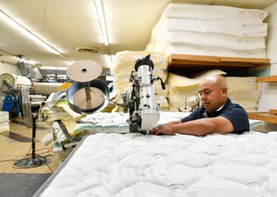 Jose Beltran, L&W Bedding co-owner, sews a mattress in the companyÕs Moline factory.